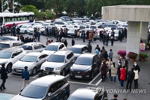 Civil servants gather outside the Jeju Self-governing Provincial Office of Education after a 4.9 magnitude earthquake struck off the southern island of Jeju on Dec. 14, 2021, in this photo provided by the office. (PHOTO NOT FOR SALE) (Yonhap)