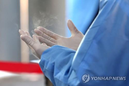 A health worker prepares to conduct COVID-19 tests at a makeshift testing station in Seoul on Jan. 12, 2022, amid a cold wave.