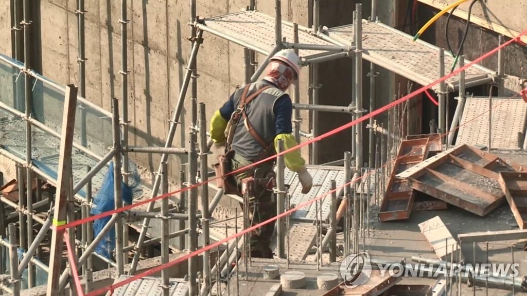 This undated file photo shows a worker at a building construction site. (Yonhap)