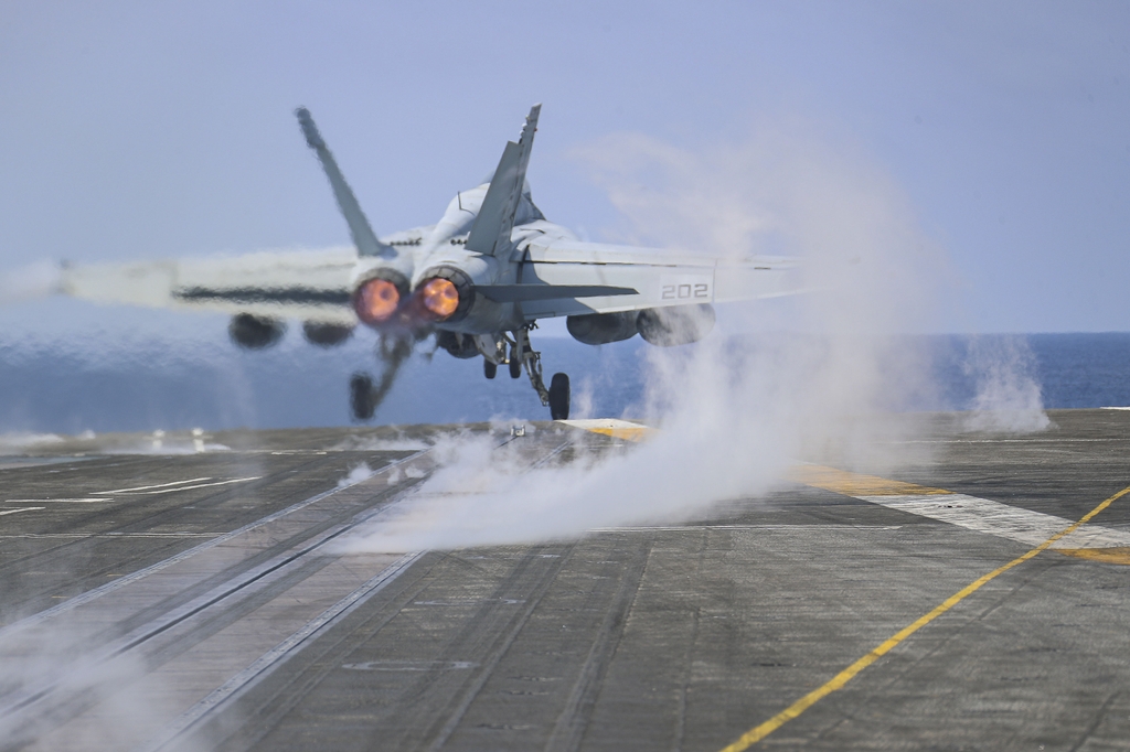 An F/A 18F Super Hornet launches from the flight deck of the USS Abraham Lincoln to stage a long-range air demonstration in the Yellow Sea in this photo released by the U.S. 7th Fleet on March 15, 2022. (PHOTO NOT FOR SALE) (Yonhap)