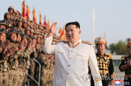 North Korean leader Kim Jong-un, wearing a white marshal uniform, waves to soldiers during a photo session on April 27, 2022, in this photo released by the Korean Central News Agency on April 29. The soldiers participated in a military parade in Pyongyang on April 25 to mark the 90th anniversary of the Korean People's Revolutionary Army. (For Use Only in the Republic of Korea. No Redistribution) (Yonhap)