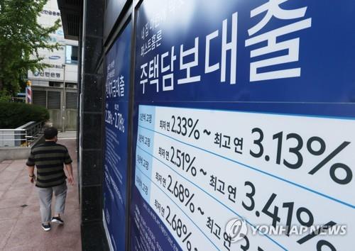 This file photo, taken Oct. 3, 2021, shows signs about a bank's loan programs on the exterior of a lender in Seoul. South Korea's financial regulator is reviewing further tightening rules on household loans in a bid to curb the fast growth of household debt. (Yonhap)