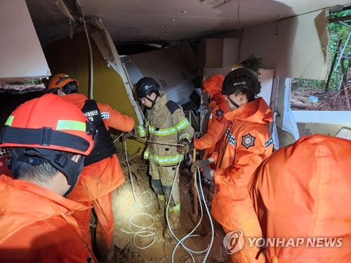 Los bomberos inician una operación de rescate en una casa afectada por un deslizamiento de tierra en Cheongyang, provincia de Chungcheong del Sur, el 15 de julio de 2023, en esta foto proporcionada por la Estación de Bomberos de Chungnam.  (FOTO NO A LA VENTA) (Yonhap)