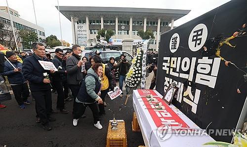 Farmers on South Korea's southern resort island of Jeju hold a ceremony against the ruling People Power Party (PPP) in front of a regional assembly building on the island on Dec. 13, 2024, as they lambasted PPP lawmakers who decided not to vote for a motion to impeach President Yoon Suk Yeol last week following Yoon's martial law declaration. (Yonhap)