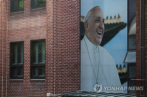 A picture of Pope Francis is hung on the outer wall of Myeongdong Cathedral in Seoul on April 21, 2025. (Yonhap)