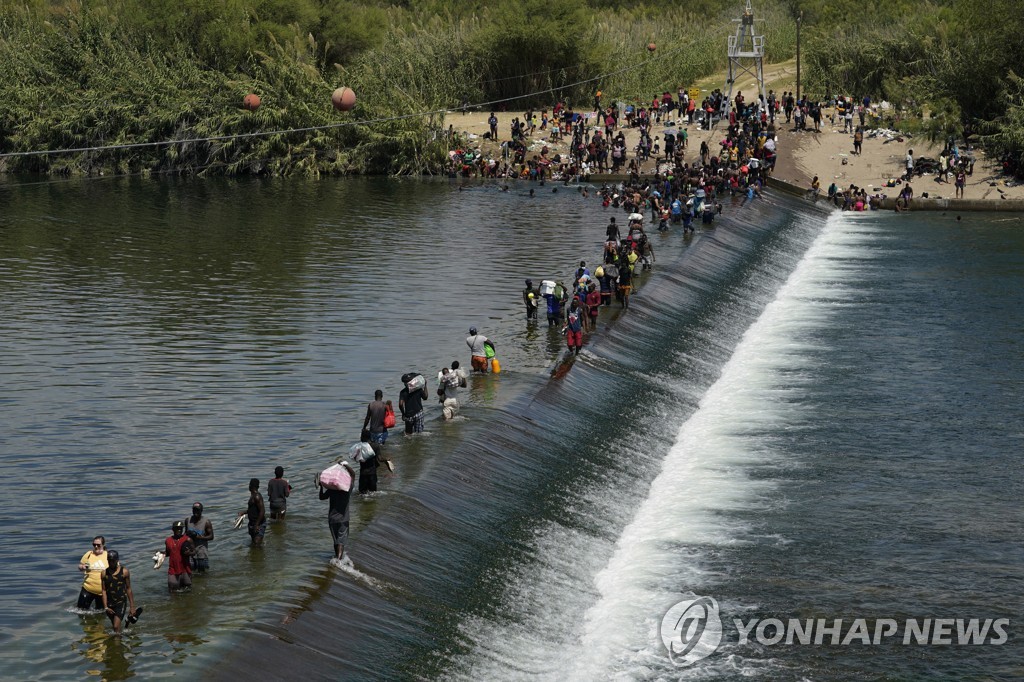 미·멕시코 국경의 리오그란데강 댐 건너는 아이티 이민자들