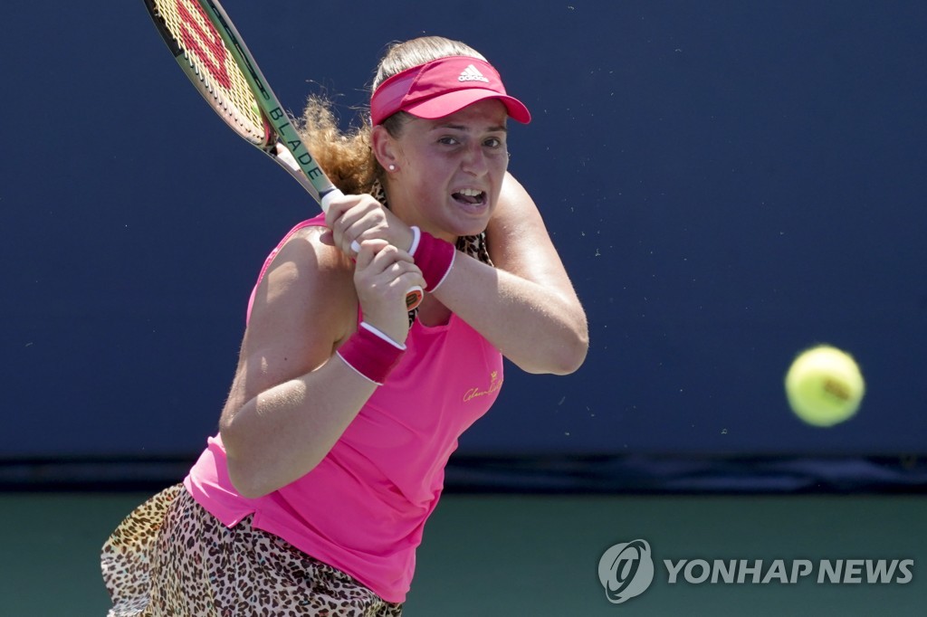 In this Associated Press file photo from Aug. 30, 2022, Jelena Ostapenko of Latvia hits a shot against Zheng Qinwen of China during their women's singles first-round match at the U.S. Open at USTA Billie Jean King National Tennis Center in New York. (Yonhap)