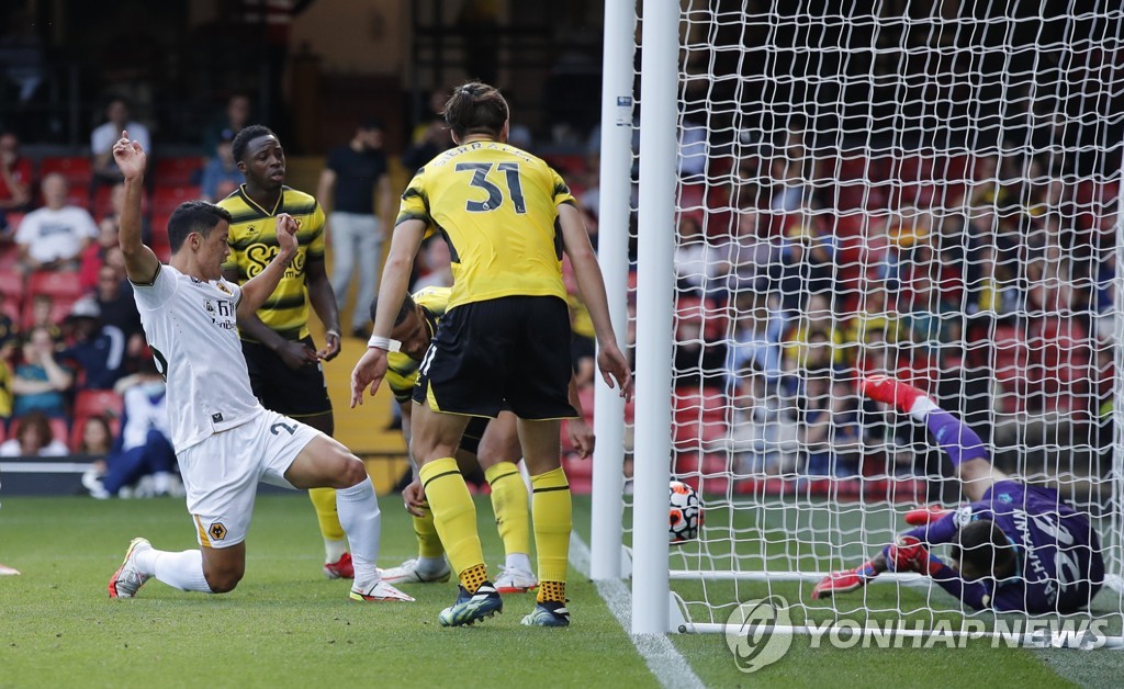 In this Action Images photo via Reuters, Hwang Hee-chan of Wolverhampton Wanderers (L) scores against Watford in a Premier League match at Vicarage Road in Watford, England, on Sept. 11, 2021. (Yonhap)