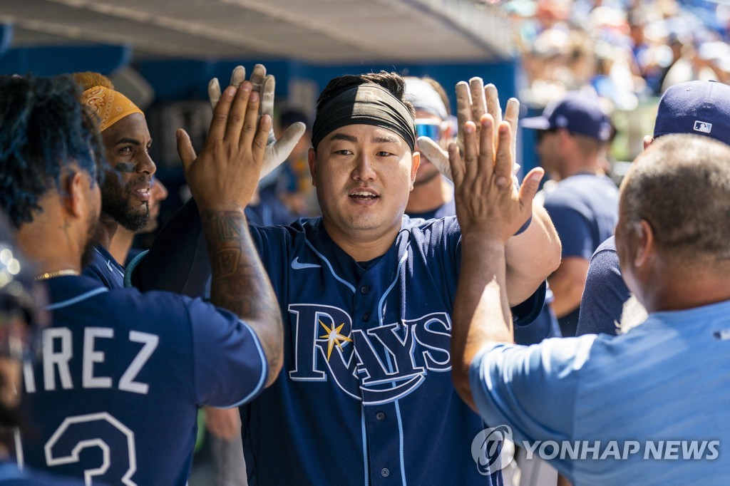 In this USA Today Sports photo via Reuters, Choi Ji-man of the Tampa Bay Rays is greeted by teammates and coaches in the dugout after hitting a solo home run against the Toronto Blue Jays during the top of the fifth inning of a Major League Baseball regular season game at Rogers Centre in Toronto on July 3, 2022. (Yonhap)