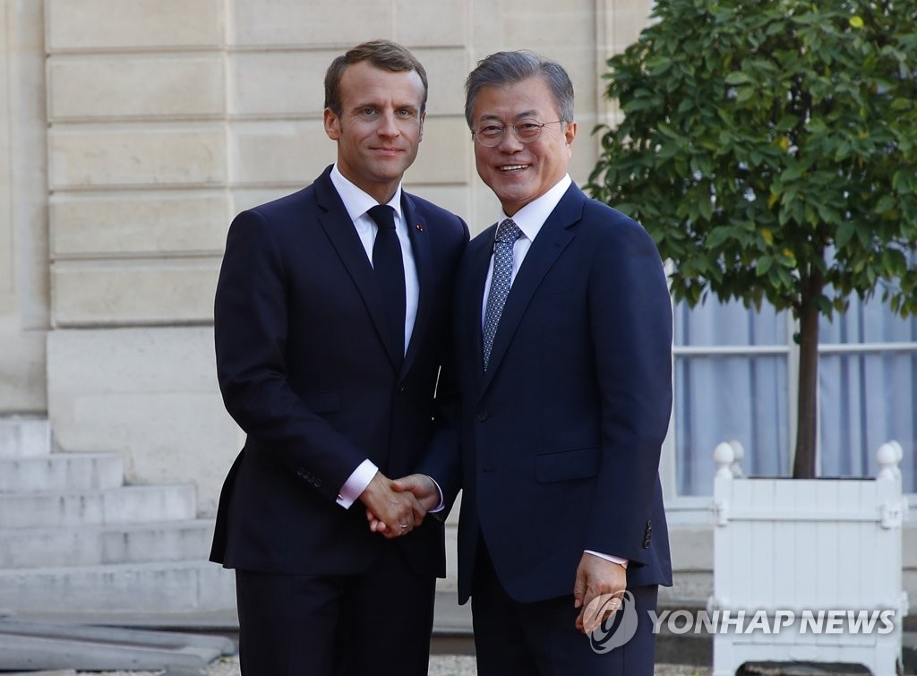South Korean President Moon Jae-in (R) and French President Emmanuel Macron shake hands after meeting for a bilateral summit at the Elysee Palace in Paris on Oct. 15, 2018. (Yonhap)