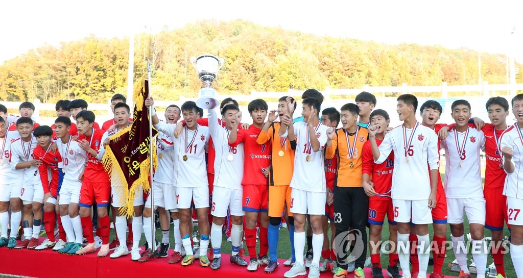 In this file photo from Nov. 2, 2018, players from South Korean (in red) and North Korean (in white) under-15 football teams run the track together after their match at the fifth Ari Sports Cup, an inter-Korean youth football tournament, at Chuncheon Songam Sports Town in Chuncheon, 85 kilometers east of Seoul. (Yonhap)