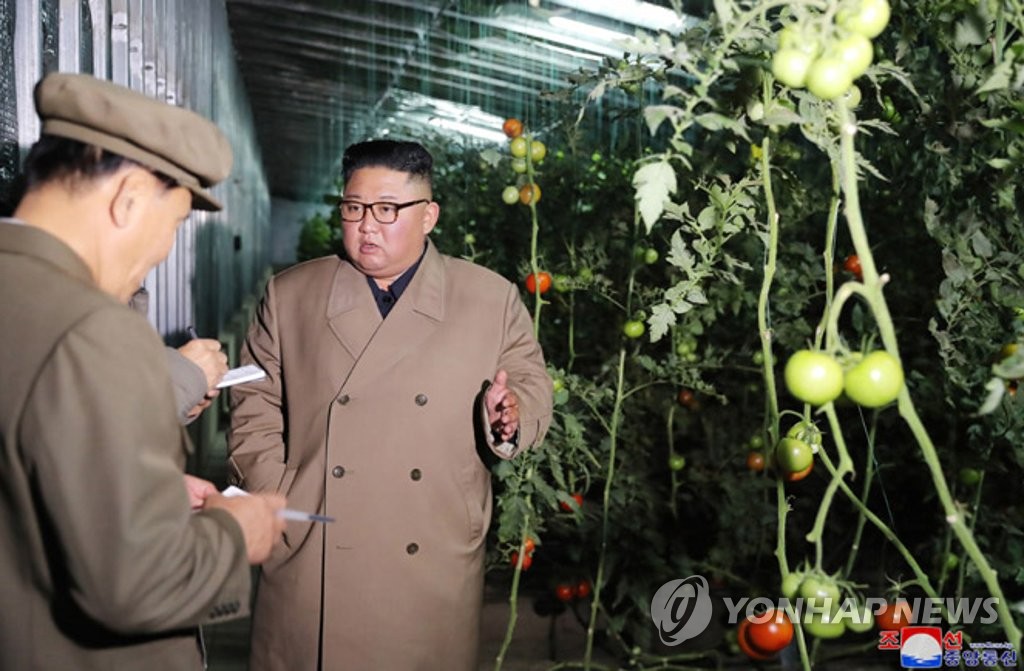 North Korean leader Kim Jong-un talks to officials during a visit to the Jungphyong Vegetable Greenhouse Farm and Tree Nursery under construction in Kyongsong County, northeastern North Korea, in this photo provided by the Korean Central News Agency on Oct. 18, 2019. (For Use Only in the Republic of Korea. No Redistribution) (Yonhap)