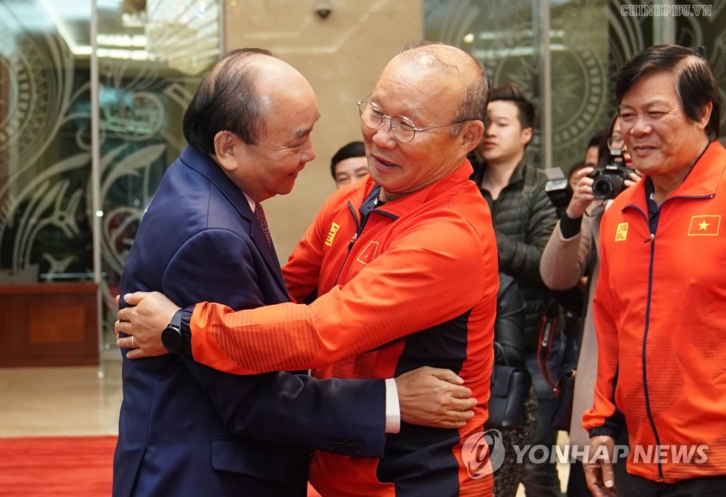In this photo taken from the Vietnamese government website, Park Hang-seo (R), South Korean head coach of the Vietnamese men's national football teams, is congratulated by Vietnamese Prime Minister Nguyen Xuan Phuc at the prime minister's official residence in Hanoi on Dec. 11, 2019, a day after coaching Vietnam to their first Southeast Asian Games gold medal in 60 years. (PHOTO NOT FOR SALE) (Yonhap)