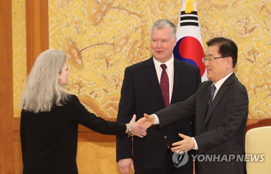 Chung Eui-yong (R), director of national security at Cheong Wa Dae, shakes hands with Allison Hooker, the White House director for Korea policy, with Special Representative for North Korea Stephen Biegun standing next to him at Cheong Wa Dae in Seoul on Dec. 16, 2019. (Yonhap)