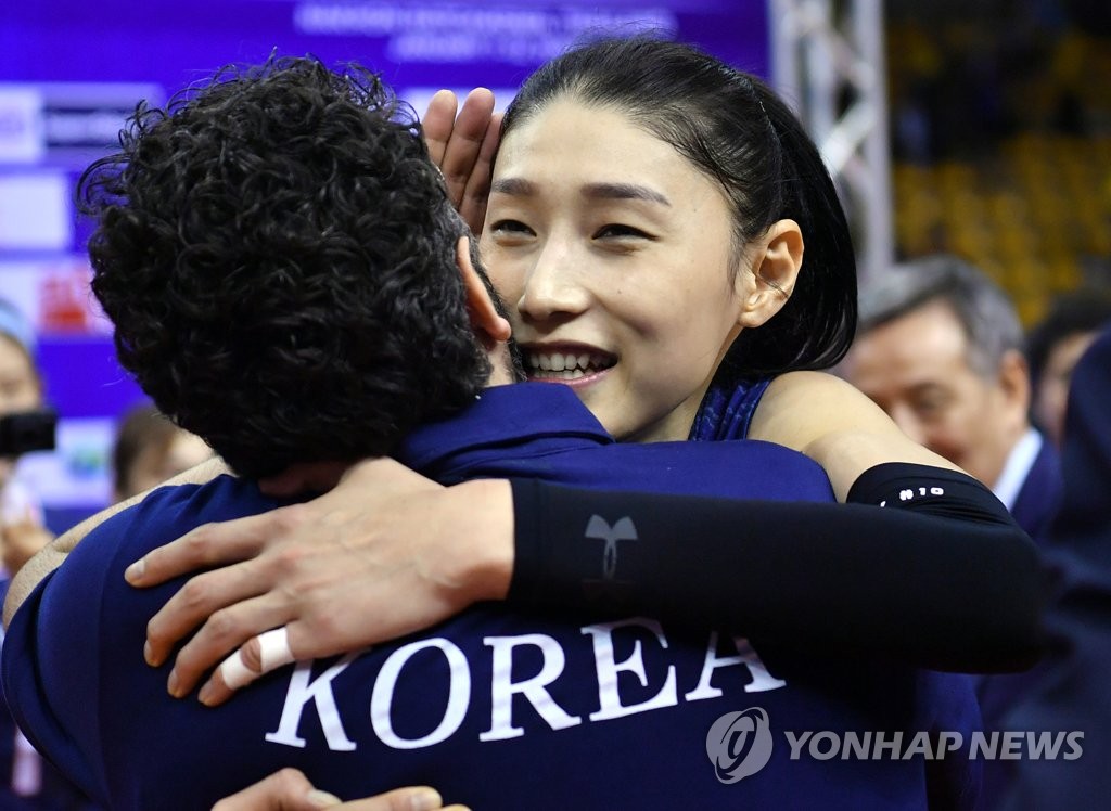 In this photo provided by FIVB on Jan. 12, 2020, South Korean captain Kim Yeon-koung (R) and her head coach Stefano Lavarini celebrate their victory over Thailand in the final of the Asian Olympic women's volleyball qualification tournament at Korat Chatchai Hall in Nakhon Ratchasima, Thailand. (PHOTO NOT FOR SALE) (Yonhap)