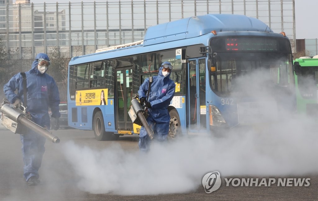 Health officials disinfect a public bus terminal in eastern Seoul on Feb. 20, 2020. (Yonhap)