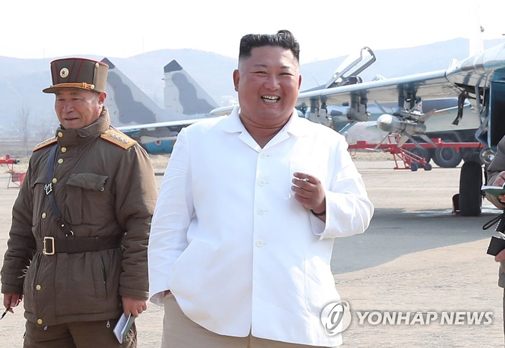 North Korean leader Kim Jong-un (R) inspects a pursuit assault plane group under the Air and Anti-Aircraft Division in the western area in this file photo released April 12, 2020, by the North's official Korean Central News Agency. South Korean officials said on April 21 that they have seen no unusual signs with regard to Kim's health after CNN reported that he is "in grave danger after a surgery." (For Use Only in the Republic of Korea. No Redistribution) (Yonhap)