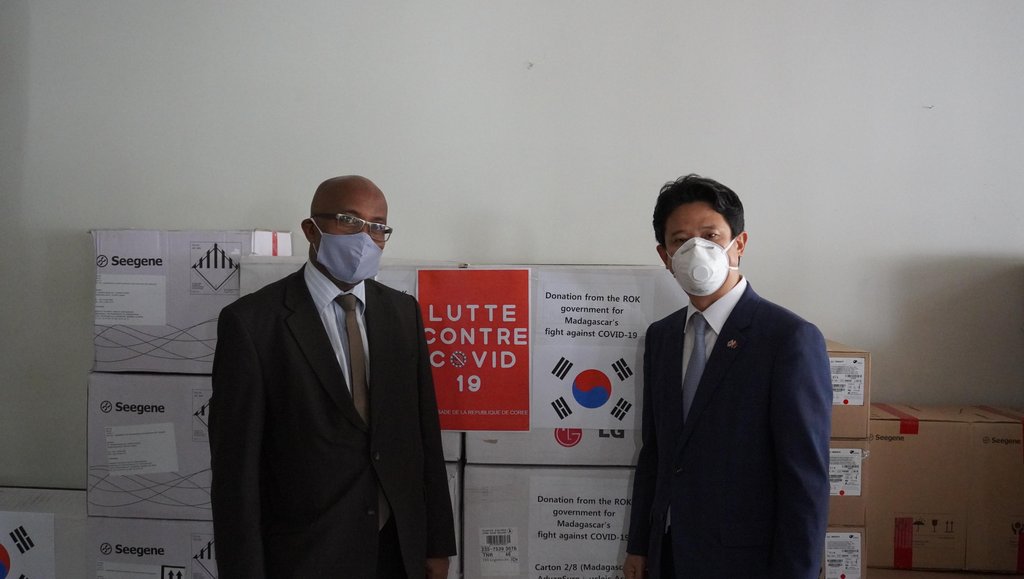 This photo, provided by the South Korean Embassy in Madagascar, shows South Korean Ambassador Lim Sang-woo (R) posing with Madagascar's Foreign Minister Djacoba Tehindrazanarivelo on April 21, 2020, in front of coronavirus test kits provided by South Korea. (PHOTO NOT FOR SALE) (Yonhap)