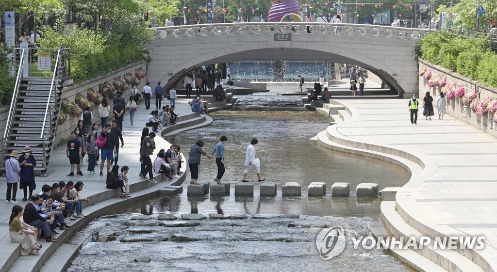 People relax at Cheonggye Stream in downtown Seoul on May 4, 2020. (Yonhap)