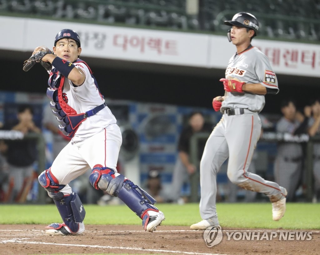 Noh Tae-hyeong of the Hanwha Eagles (R) is forced out at home by Lotte Giants catcher Ji Seong-jun during a Korea Baseball Organization regular season game against the Lotte Giants at Sajik Stadium in Busan, 450 kilometers southeast of Seoul, on June 11, 2020. (Yonhap)