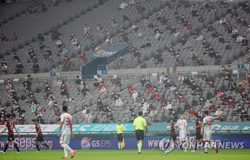 In this file photo from Aug. 15, 2020, fans attend a K League 1 match between the home team FC Seoul and Sangju Sangmu at Seoul World Cup Stadium in Seoul. (Yonhap)