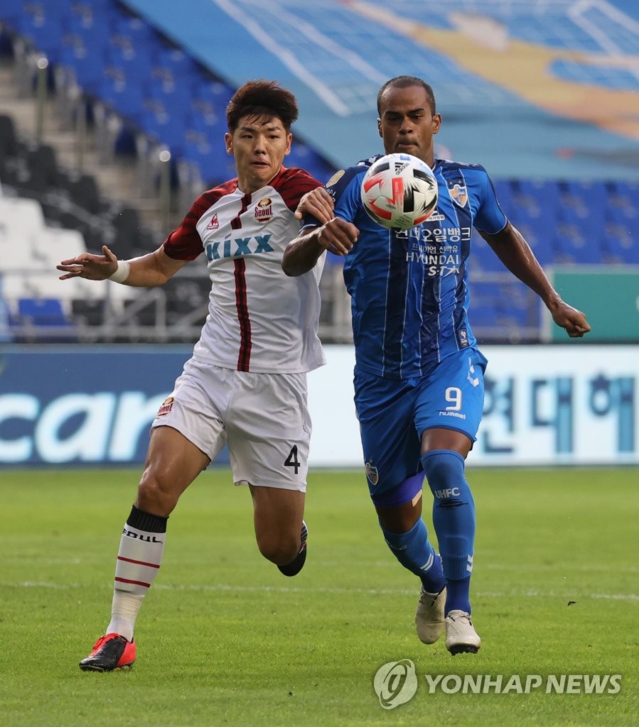 Junior Negrao of Ulsan Hyundai FC (R) and Kim Nam-chun of FC Seoul battle for the ball during a K League 1 match at Ulsan Munsu Football Stadium in Ulsan, 415 kilometers southeast of Seoul, on Aug. 30, 2020. (Yonhap)