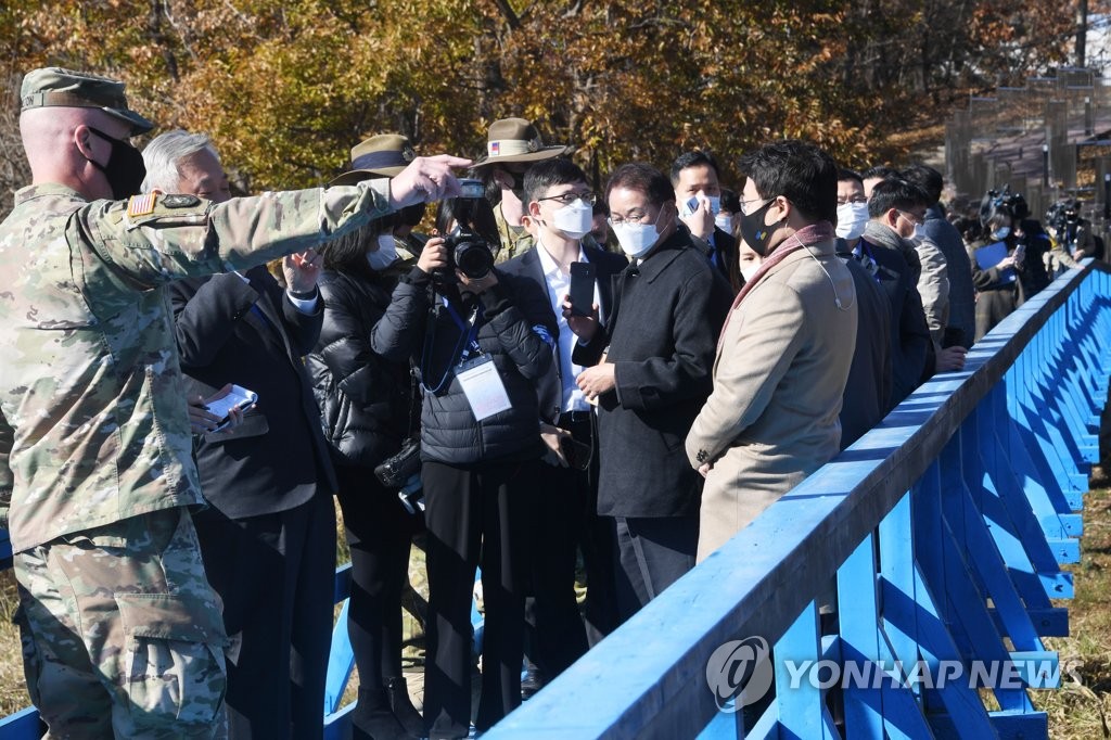 A group of people, including journalists, visits the truce village of Panmunjom, in this photo provided by Press Corps on Nov. 4, 2020, as a tour program resumed after more than a year of suspension due to African swine fever.