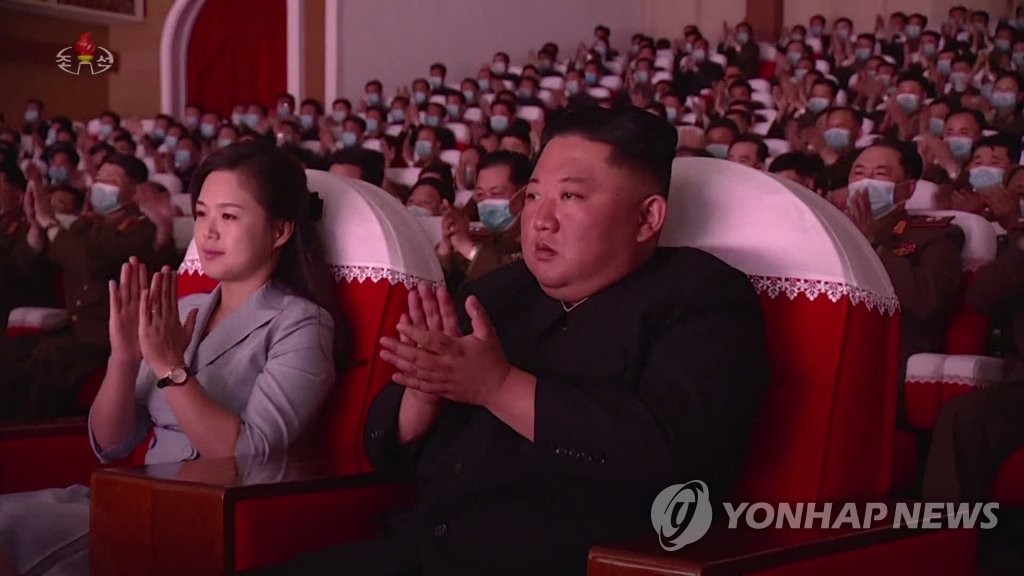 North Korean leader Kim Jong-un (R) and his wife, Ri Sol-ju, applaud as they attend a performance given by the art groups of servicemen's families from large combined units of the Korean People's Army at the Mansudae Art Theatre in Pyongyang on May 5, 2021, in this photo captured from the North's Korean Central Television the next day. (For Use Only in the Republic of Korea. No Redistribution) (Yonhap)