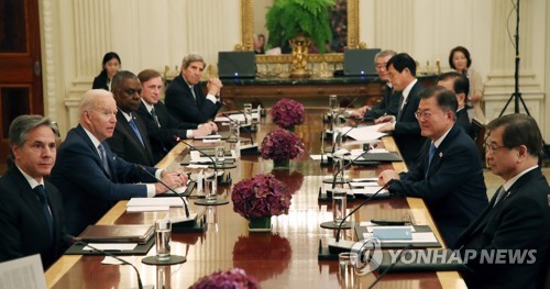 拡大会談を行う文大統領（右列手前から２人目）とバイデン大統領（左列同２人目）＝２１日、ワシントン（聯合ニュース）