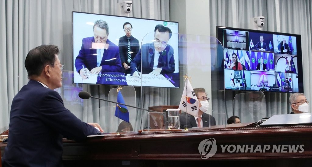 South Korean President Moon Jae-in (L) participates in the fourth South Korea-Central American Integration System summit, held via video links, at Cheong Wa Dae in Seoul on June 25, 2021. (Yonhap) 