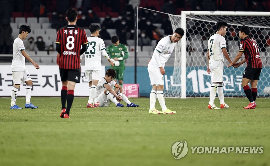 Members of Gangwon FC (in white) and FC Seoul react to a scoreless draw in their K League 1 match at Jamsil Olympic Stadium in Seoul on Nov. 28, 2021. (Yonhap)