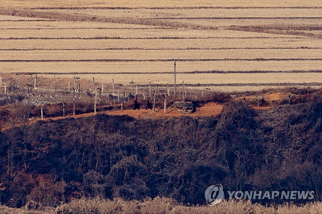 This photo, taken from a South Korean observation tower in Paju, north of Seoul, shows North Korean soldiers moving along a barbed wire fence in the western border town of Kaepung, North Hwanghae Province, on Jan. 5, 2022, when North Korea launched an apparent ballistic missile toward the East Sea at around 8:10 a.m. from a land-based platform. (Yonhap)