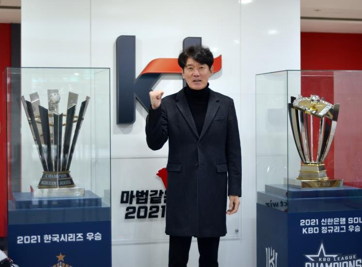 KT Wiz manager Lee Kang-chul poses next to the team's 2021 Korean Series trophy (L) and the regular season championship trophy at KT Wiz Park in Suwon, about 45 kilometers south of Seoul, on Jan. 17, 2022. (Yonhap)