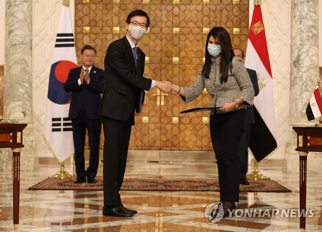 This photo, taken Jan. 20, 2022, shows Bang Moon-Kyu (L), chief of the state-run Export-Import Bank of Korea (Exim Bank), shaking hands with Rania A. Al-Mashat, Egypt's international cooperation minister, after they clinched a memorandum of understanding over the 2022-26 Economic Development Cooperation Fund. (Yonhap)