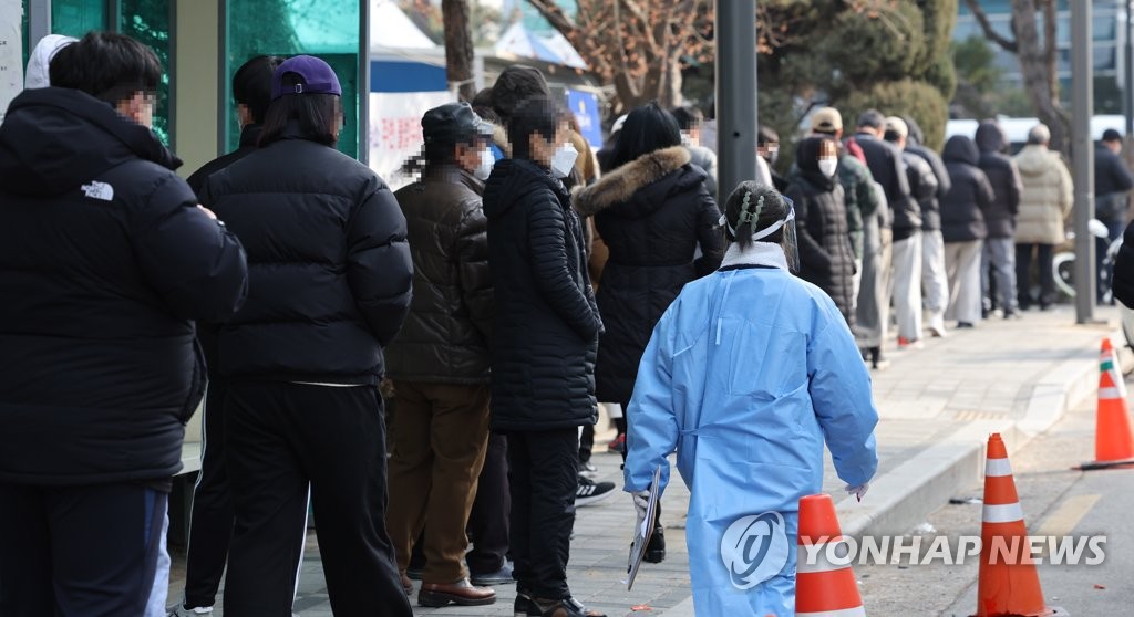 People wait in line to receive COVID-19 tests in Seoul on Jan. 23, 2022, as South Korea's daily coronavirus cases spiked to the second-largest figure since the pandemic began amid the fast spread of the omicron variant.