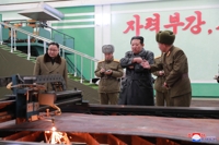 (3rd LD) N. Korea confirms missile tests, leader Kim visits munitions factory