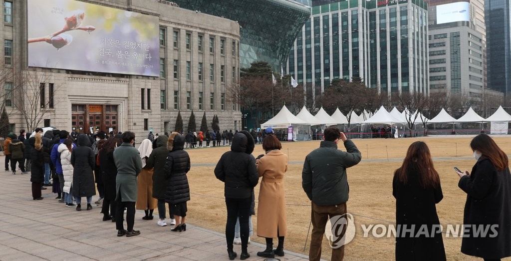 People wait in line to receive tests at a COVID-19 testing station in Seoul on Feb. 15, 2022, as new daily cases hit a fresh high of 57,177. (Yonhap)