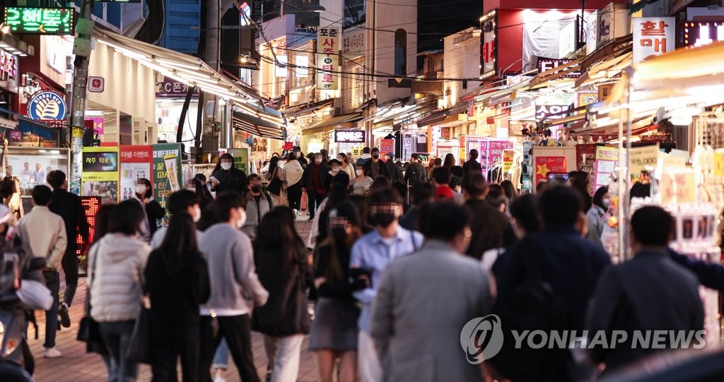A small street in the popular Hongdae district in Seoul is crowded with people on March 31, 2022. (Yonhap)