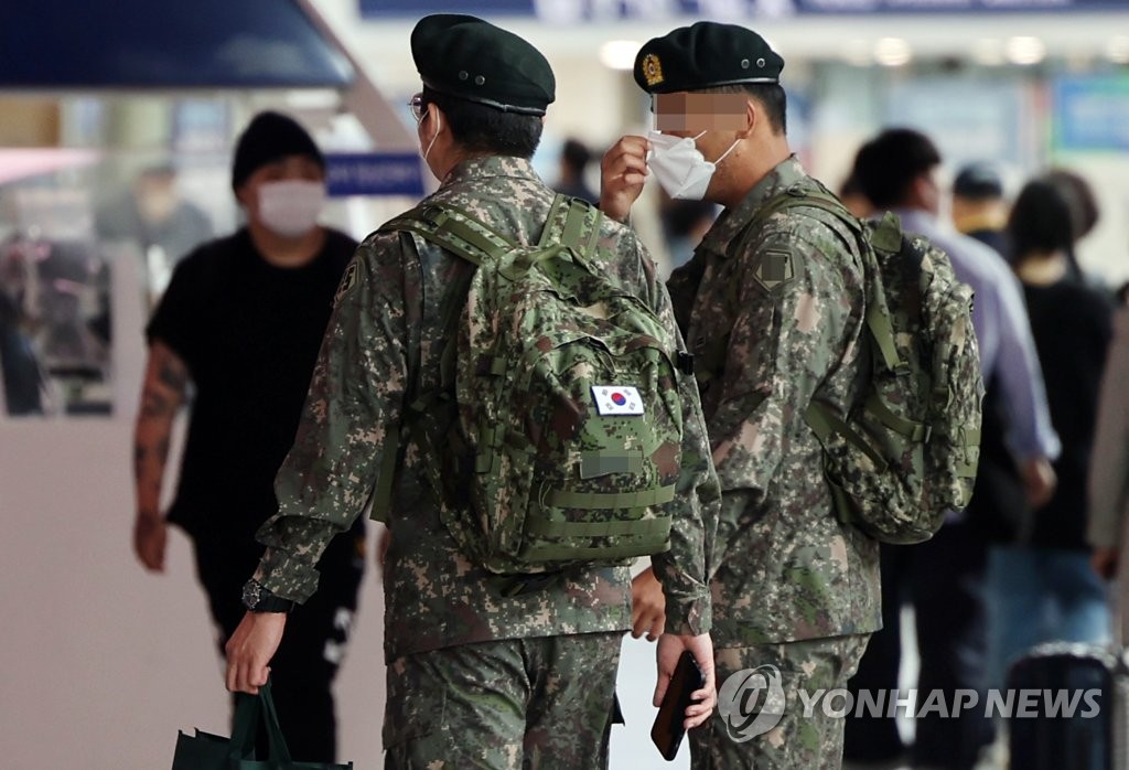 This file photo taken April 29, 2022, shows service members walking by a train at Seoul Station in central Seoul. (Yonhap)