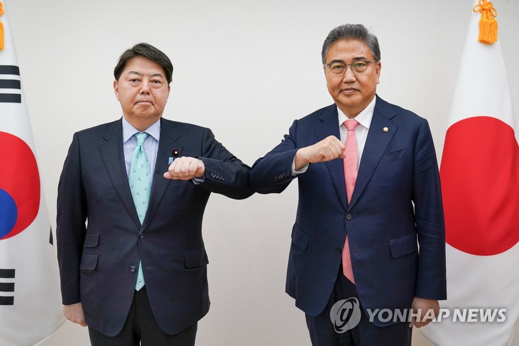 In this file photo provided by South Korea's foreign ministry on May 9, 2022, Park Jin (R), then foreign minister-designate, and Japanese Foreign Minister Yoshimasa Hayashi bump elbows during their meeting in Seoul. (PHOTO NOT FOR SALE) (Yonhap)