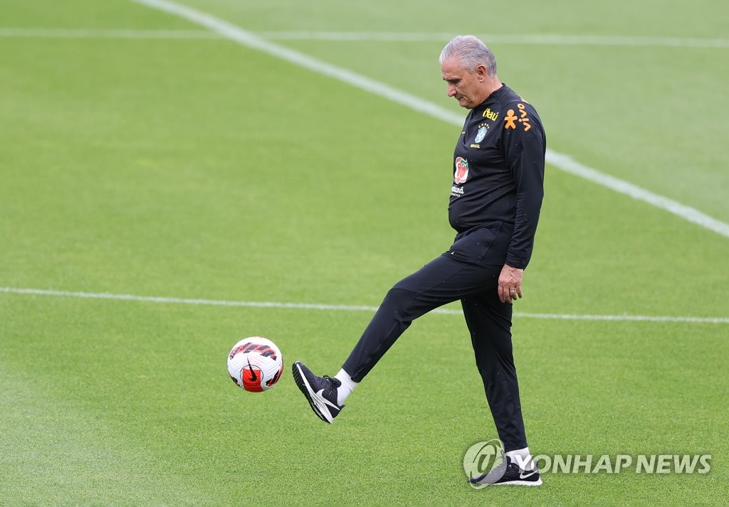 Tite, head coach of the Brazilian men's national football team, kicks a ball during a training session at Seoul World Cup Stadium in Seoul on June 1, 2022, the eve of a friendly match against South Korea. (Yonhap)