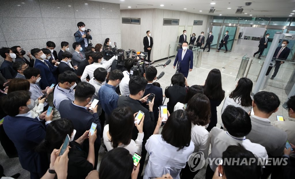 President Yoon Suk-yeol answers reporters' questions while reporting to work at the presidential office in Seoul on June 7, 2022. (Pool photo) (Yonhap)