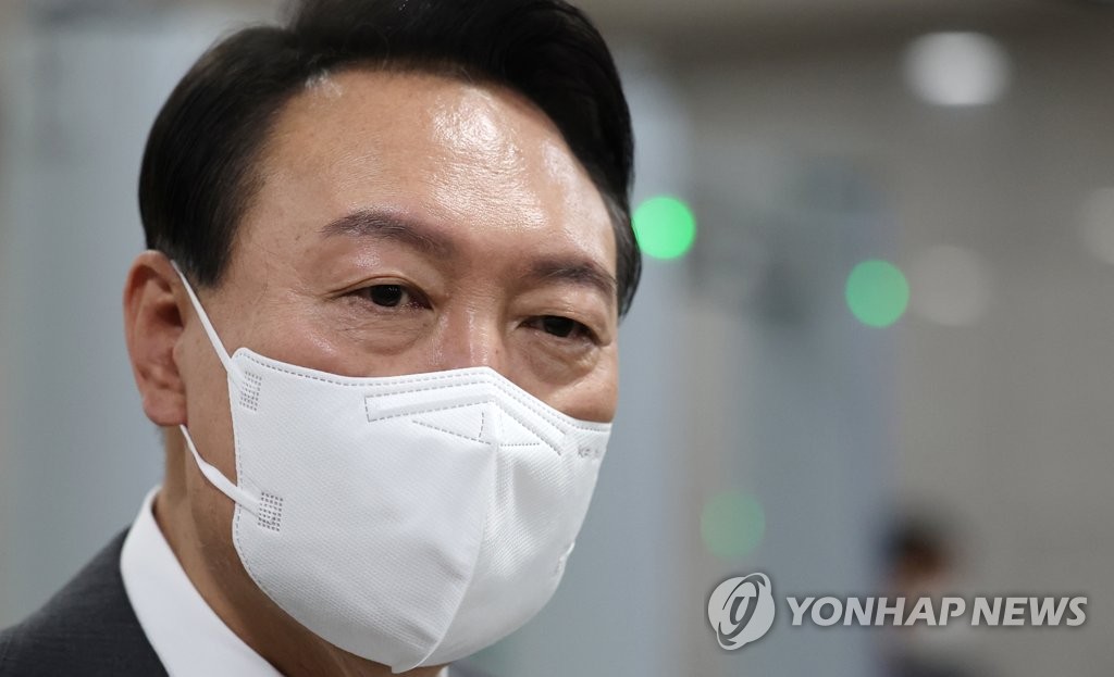 President Yoon Suk-yeol takes reporters' questions as he arrives at the presidential office in Seoul on June 15, 2022. (Yonhap)
