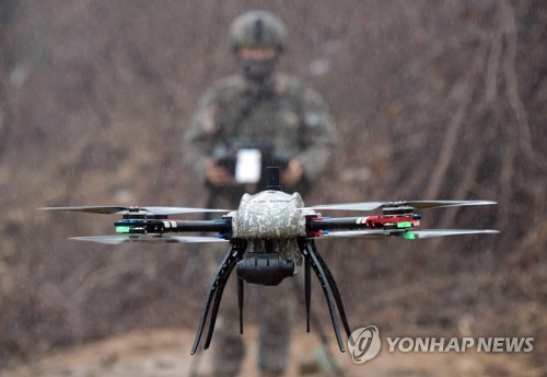 This photo, taken on Jan. 13, 2023, shows a soldier operating a surveillance drone during military drills in Paju, northwest of Seoul. (Pool photo) (Yonhap)