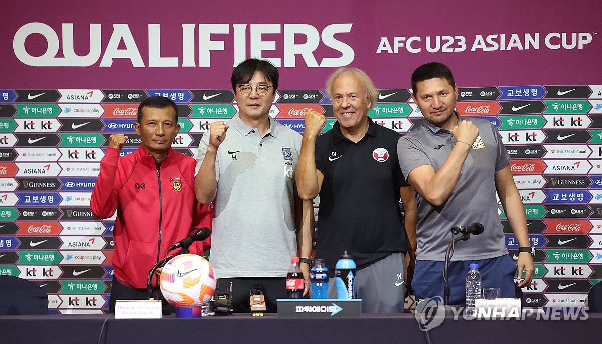 The head coaches of the four participating countries in the 2024 Asian Football Confederation U-23 Asian Cup qualifying tournament in the southeastern city of Changwon pose for photos during their joint press conference on Sept. 5, 2023. From left: U Aung Naing of Myanmar, Hwang Sun-hong of South Korea, Ilidio Vale of Qatar and Anarbek Ormombekov of Kyrgyzstan. (Yonhap)