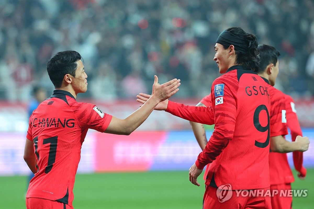 Hwang Hee-chan of South Korea (L) high-fives teammate Cho Gue-sung after scoring against Singapore during the teams' Group C match in the second round of the Asian World Cup qualification tournament at Seoul World Cup Stadium in Seoul on Nov. 16, 2023. (Yonhap)