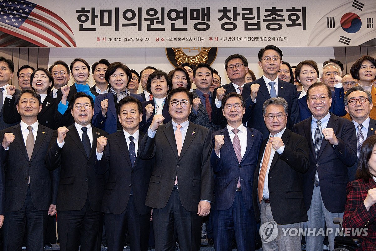 Los legisladores gobernantes y de oposición posan para una foto con funcionarios del gobierno y diplomáticos en una reunión general de un organismo parlamentario destinado a fortalecer la alianza de Corea del Sur en el Hall de la Constitución de la Asamblea Nacional en Seúl el 10 de marzo de 2025. (Foto de la piscina) (Yonhap)