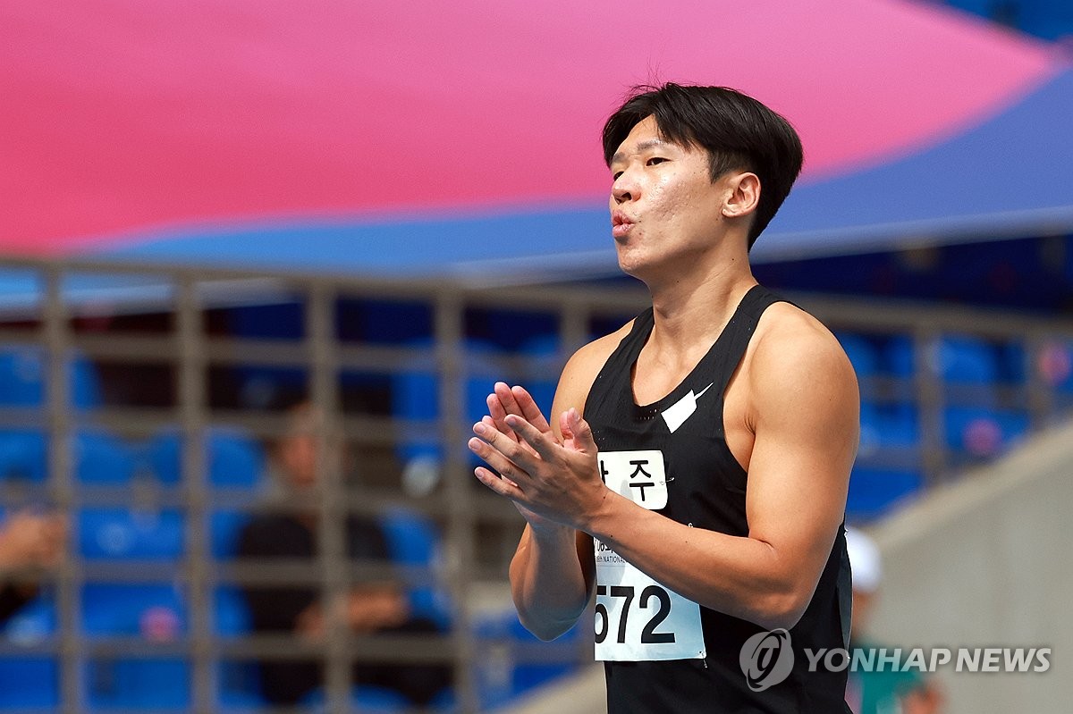 함께 예선 출전한 선수들 기록 보며 손뼉치는 김국영